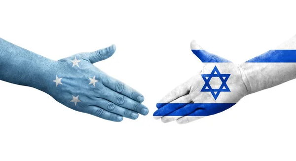 手に描かれたミクロネシア連邦とイスラエルの旗の間の握手 隔離された透明なイメージ — ストック写真