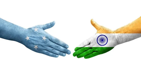 stock image Handshake between Micronesia and India flags painted on hands, isolated transparent image.