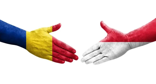 stock image Handshake between Monaco and Romania flags painted on hands, isolated transparent image.