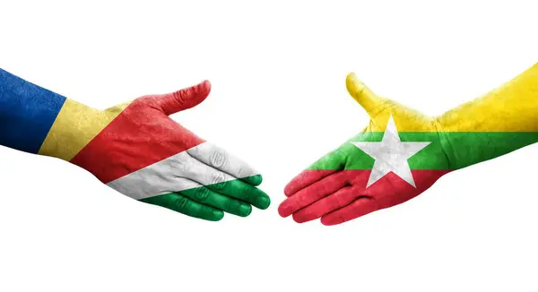 stock image Handshake between Myanmar and Seychelles flags painted on hands, isolated transparent image.