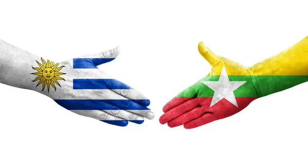 stock image Handshake between Myanmar and Uruguay flags painted on hands, isolated transparent image.