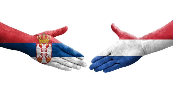 Χειραψία Μεταξύ Ολλανδίας Και Σερβίας Ζωγραφισμένες Σημαίες Στα Χέρια Απομονωμένη — Φωτογραφία Αρχείου