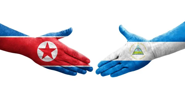 Händedruck Zwischen Nicaragua Und Nordkorea Flaggen Auf Hände Gemalt Isoliertes — Stockfoto
