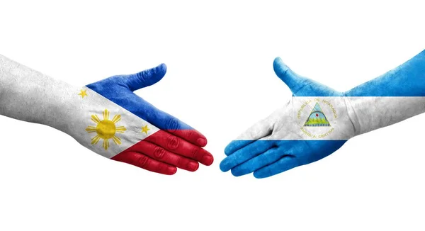 Uścisk Dłoni Między Nikaraguą Filipinami Flagi Malowane Rękach Odizolowany Przezroczysty — Zdjęcie stockowe