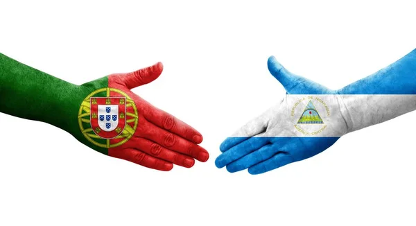 Uścisk Dłoni Między Nikaraguą Portugalią Flagi Malowane Rękach Odizolowany Przezroczysty — Zdjęcie stockowe