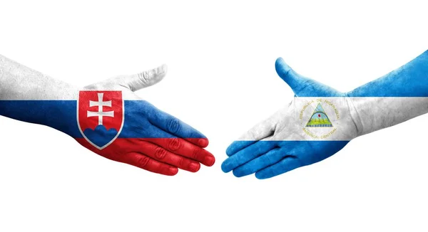 stock image Handshake between Nicaragua and Slovakia flags painted on hands, isolated transparent image.