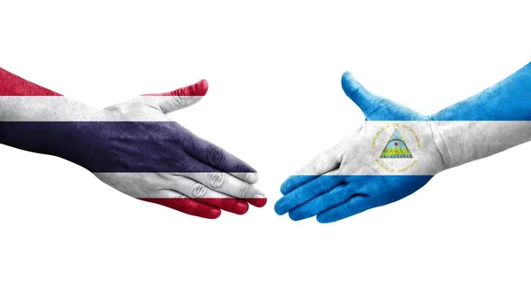 Χειραψία Μεταξύ Νικαράγουας Και Ταϊλάνδης Σημαίες Ζωγραφισμένα Στα Χέρια Απομονωμένη — Φωτογραφία Αρχείου
