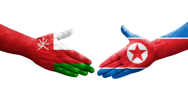 Händedruck Zwischen Nordkorea Und Oman Flaggen Auf Hände Gemalt Isoliertes — Stockfoto
