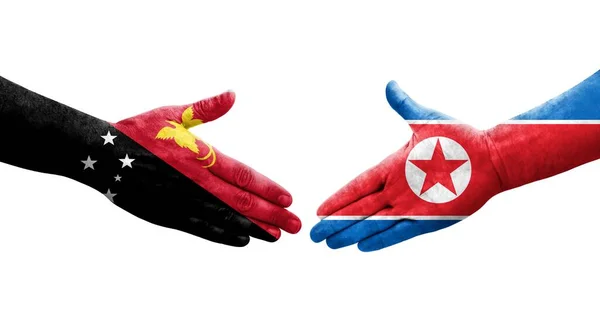 北朝鮮とパプアニューギニアの旗の間の握手手に描かれた 孤立した透明なイメージ — ストック写真