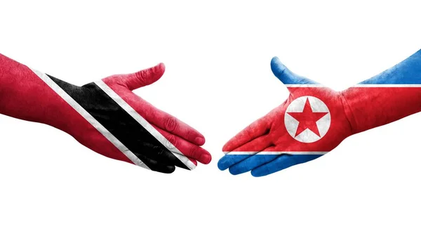 Handslag Mellan Nordkorea Och Trinidad Tobago Flaggor Målade Händer Isolerad — Stockfoto