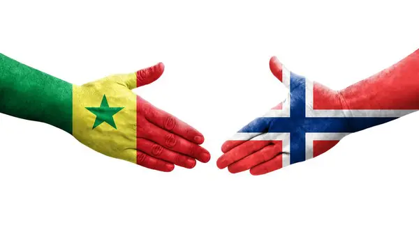 stock image Handshake between Norway and Senegal flags painted on hands, isolated transparent image.