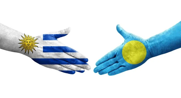Händedruck Zwischen Palau Und Uruguay Flaggen Auf Händen Gemalt Isoliertes — Stockfoto