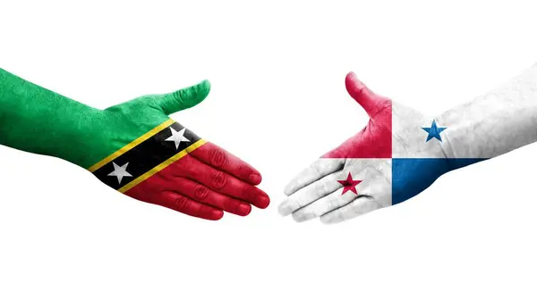 stock image Handshake between Panama and Saint Kitts and Nevis flags painted on hands, isolated transparent image.