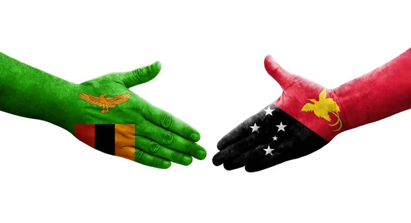 Рукостискання Між Папуаською Новою Гвінеєю Замбійськими Прапорами Намальоване Руках Ізольоване — стокове фото