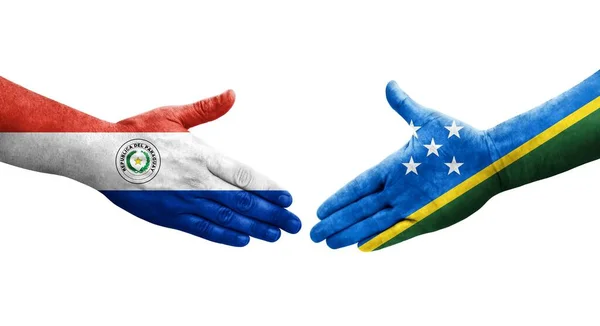 stock image Handshake between Paraguay and Solomon Islands flags painted on hands, isolated transparent image.