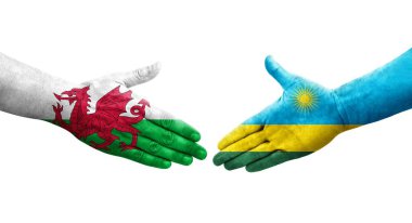 Ruanda ve Galler arasındaki el sıkışma ellerinde boyanmış bayraklar, izole edilmiş şeffaf görüntü.