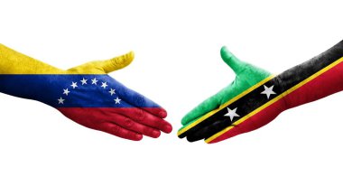 Saint Kitts ve Nevis arasındaki el sıkışma ve ellerinde Venezuela bayrakları, izole şeffaf görüntü.