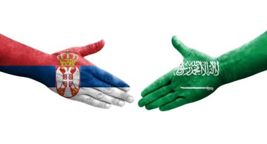 Suudi Arabistan ile Sırbistan arasındaki el sıkışma ellerinde bayraklar, izole edilmiş şeffaf görüntü.