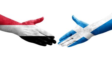 İskoçya ve Yemen bayrakları arasındaki el sıkışma ellerinde resmedilmiş şeffaf bir görüntü.