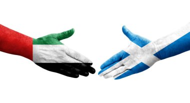 İskoçya ve BAE bayrakları arasındaki el sıkışma, izole edilmiş şeffaf görüntü.