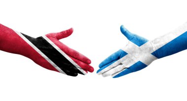 İskoçya ve Trinidad Tobago bayrakları arasındaki el sıkışma ellerinde izole şeffaf görüntü.