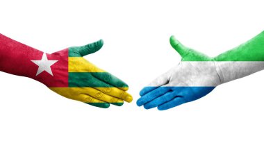 Sierra Leone ve Togo bayrakları arasındaki tokalaşma elleri boyalı, izole şeffaf görüntü.