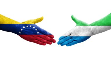 Sierra Leone ve Venezuela bayrakları arasındaki el sıkışma ellerinde izole şeffaf görüntü.