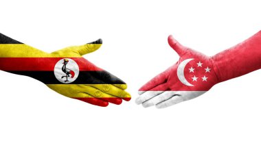 Singapur ve Uganda bayrakları arasındaki el sıkışma ellere boyanmış, izole şeffaf görüntü.