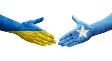 Ellere boyanmış Somali ve Ukrayna bayrakları arasındaki el sıkışma, izole şeffaf görüntü.