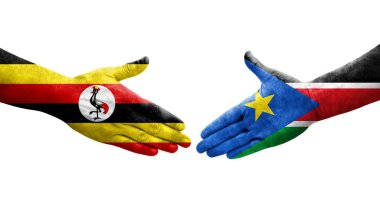 Güney Sudan ve Uganda bayrakları arasındaki tokalaşma elleri boyalı, izole şeffaf görüntü.