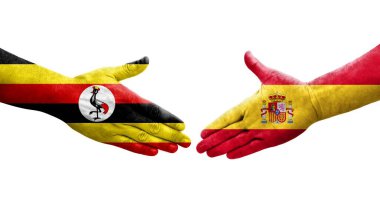 İspanya ve Uganda bayrakları arasındaki el sıkışma, izole şeffaf görüntü.