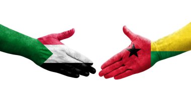 Sudan ve Gine Bissau bayrakları arasındaki tokalaşma elleri boyalı, izole şeffaf görüntü.