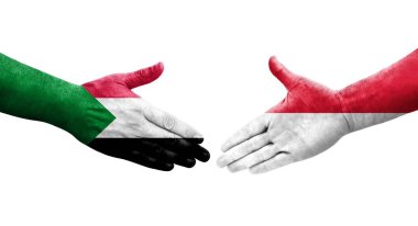 Sudan ve Monako bayrakları arasındaki el sıkışma ellerinde resmedilmiş şeffaf görüntü.