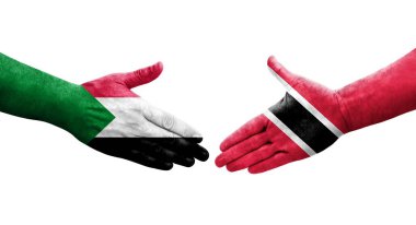 Sudan ve Trinidad Tobago bayrakları arasındaki tokalaşma elleri boyalı, izole şeffaf görüntü.