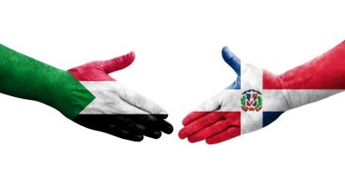 Sudan ve Dominik Cumhuriyeti bayrakları arasındaki el sıkışma, izole şeffaf görüntü.