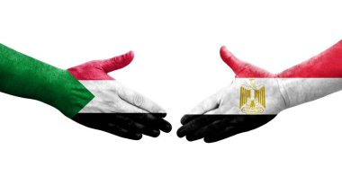 Sudan ve Mısır bayrakları arasındaki el sıkışma ellerinde resmedilmiş şeffaf görüntü.