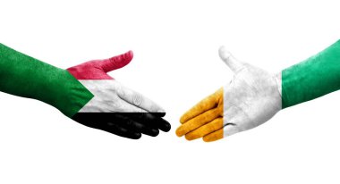 Sudan ve Fildişi Sahili bayrakları arasında el sıkışma, izole şeffaf görüntü.
