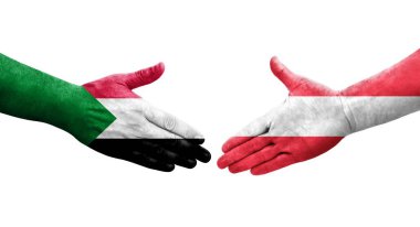 Sudan ve Avusturya bayrakları arasındaki tokalaşma elleri boyalı, izole şeffaf görüntü.