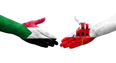 Sudan ve Cebelitarık bayrakları arasındaki tokalaşma elleri boyalı, izole şeffaf görüntü.