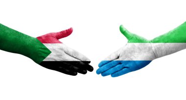 Sudan ve Sierra Leone bayrakları arasındaki tokalaşma elleri boyalı, izole şeffaf görüntü.