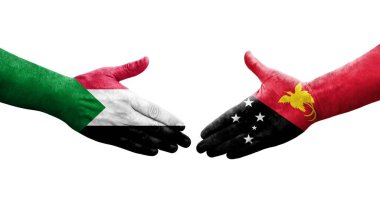 Sudan ve Papua Yeni Gine bayrakları arasındaki el sıkışma ellerinde izole şeffaf görüntü.