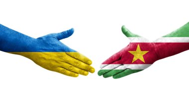 Surinam ve Ukrayna bayrakları arasında el sıkışma, izole şeffaf görüntü.