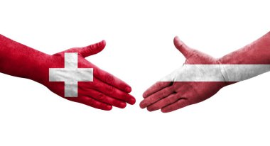 İsviçre ve Letonya bayrakları arasındaki el sıkışma, izole şeffaf görüntü.