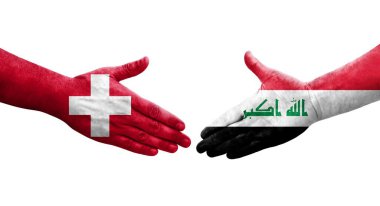 İsviçre ve Irak bayrakları arasında el sıkışma, izole şeffaf görüntü.