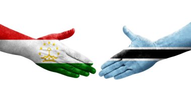 Tacikistan ve Botsvana bayrakları arasındaki el sıkışma, izole şeffaf görüntü.