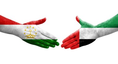 Tacikistan ve BAE bayrakları arasındaki el sıkışma, izole şeffaf görüntü.
