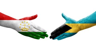 Tacikistan ve Bahamalar arasındaki el sıkışma ellerinde boyanmış bayraklar, izole şeffaf görüntü.