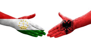 Tacikistan ve Arnavutluk bayrakları arasındaki el sıkışma, izole edilmiş şeffaf görüntü.