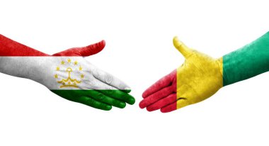 Tacikistan ve Gine bayrakları arasındaki el sıkışma, izole şeffaf görüntü.