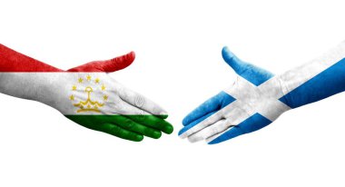 Tacikistan ve İskoçya bayrakları arasındaki el sıkışma, izole şeffaf görüntü.